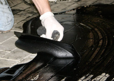 grout being applied to tiles