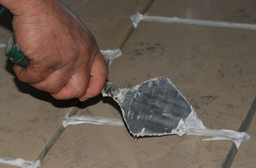 mortar being applied to vitrified tiles